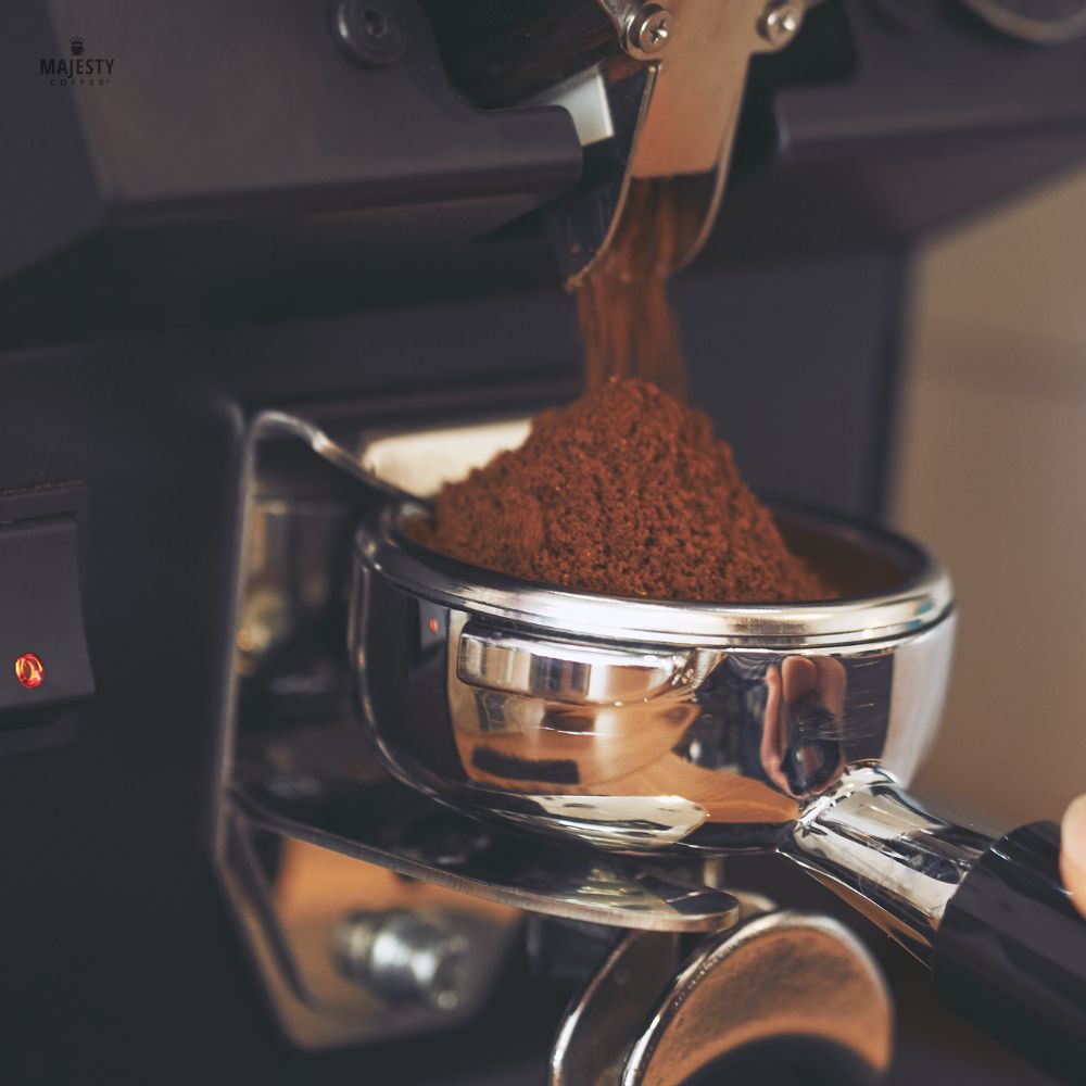 Freshly ground coffee dosing from a grinder into a portafilter